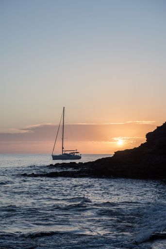 A vertical shot of a sunset with a boat on the shore in Fuerteventura, Canary Islands, Spain