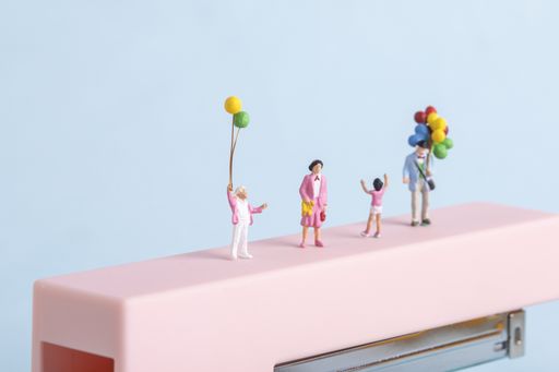 A closeup shot of people figures with balloons on blue background