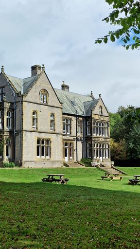A YHA castleton loosehill hall with trees and grass around