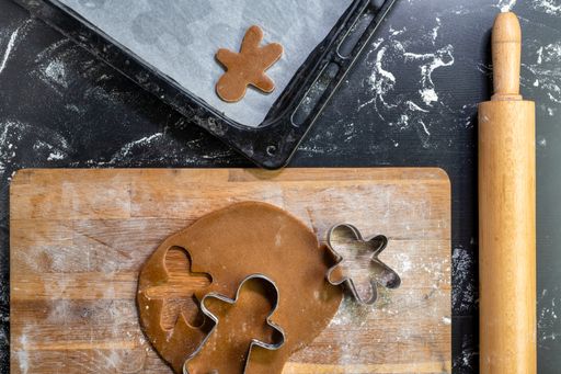 a top view of gingerbread man cookies and cookie cutters