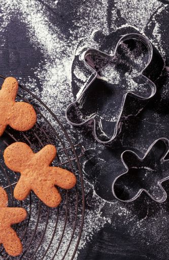 a top view of gingerbread man cookies and cookie cutters