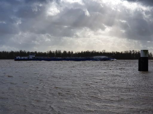 The sunrise over the Merwede river, the Netherlands on a cloudy day