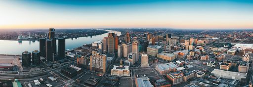 Panoramic photo of Detroit, MI in November of 2020.  Photo also features Windsor Canada across the river.  Photo features Renaissance Center.
