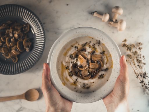 A top view shot of delicious creamy soup with mushroom