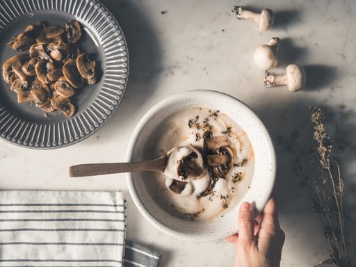 A top view shot of delicious creamy soup with mushroom