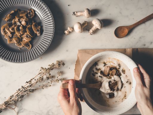 A top view shot of delicious creamy soup with mushroom