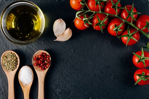 An overhead shot of colorful food ingredients on a black background
