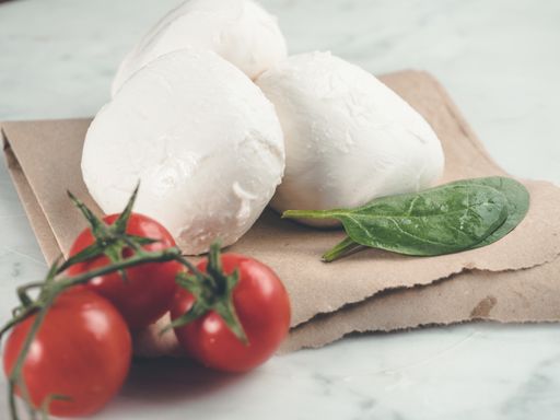 A closeup shot of mozzarella and cherry tomatoes on a plate
