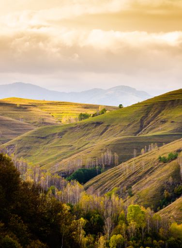 A beautiful landscape with the famous Apuseni Mountains range in Romania under a cloudy sky