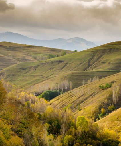 A beautiful landscape with the famous Apuseni Mountains range in Romania under a cloudy sky
