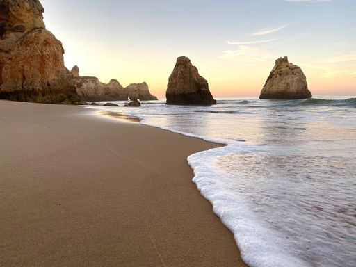 A beautiful view of the beach against scenic sunset in Alvor, Portugal