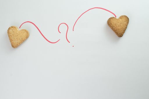 A flat lay of heart shaped cookies on a table - the concept of love in distance