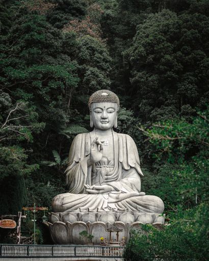 A vertical shot of the giant white Buddha statue at Genting Highlands in Malaysia