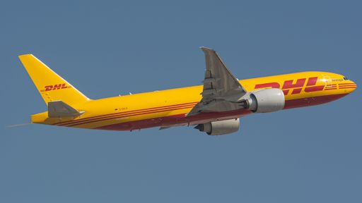 A closeup of the Boeing 767 DHL in a flight on a blue sky background