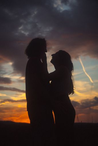 loving couple kissing each other during sunset