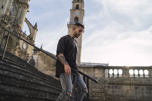 A selective focus shot of an attractive male coming down the stairs