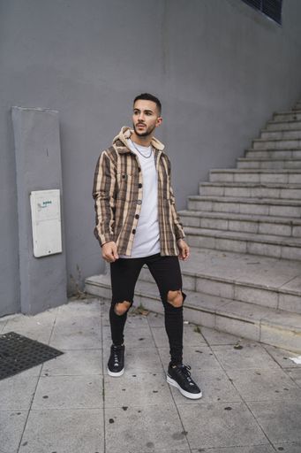A vertical shot of an attractive male coming down the stairs