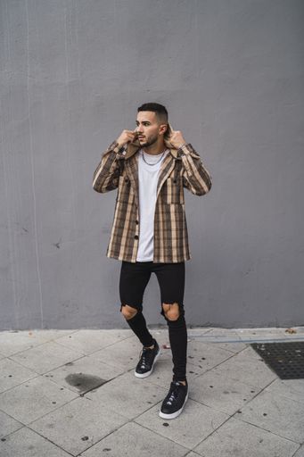 A vertical shot of a handsome male posing in front of the camera
