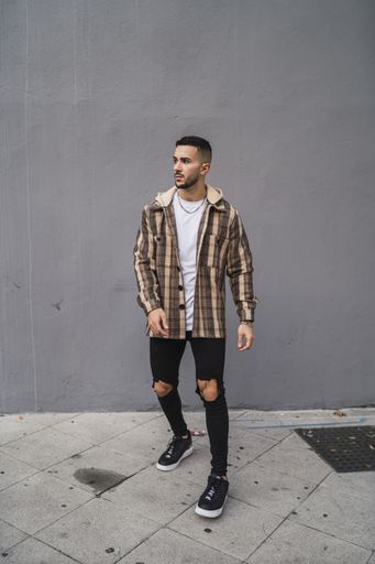 A vertical shot of a handsome male posing in front of the camera