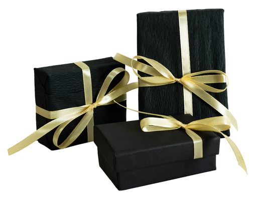 A closeup of black Christmas gift boxes with ribbons isolated on a white background