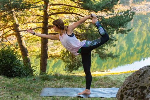 A young caucasian female during her workout in the forest