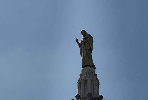 A low angle shot of a religious statue in the city of Bilbao