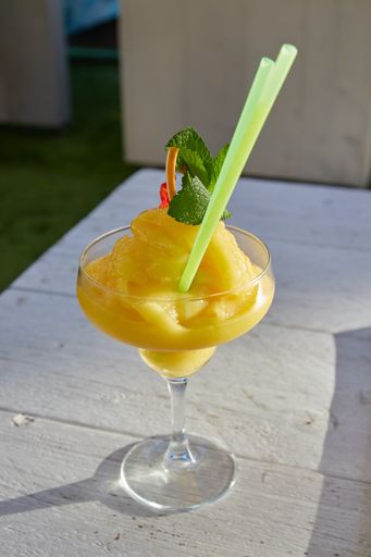 Delicious Mango Daiquiri cocktail in a white background on a sunny day