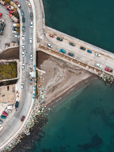 A vertical aerial view of roads with cars near the water in Plomari,Lesvos,Greece
