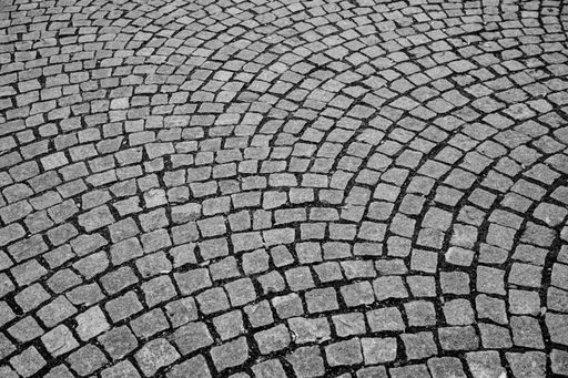 A high angle shot of a gray cobblestone road
