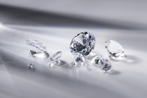 A closeup shot of beautifully cut diamonds on a white surface