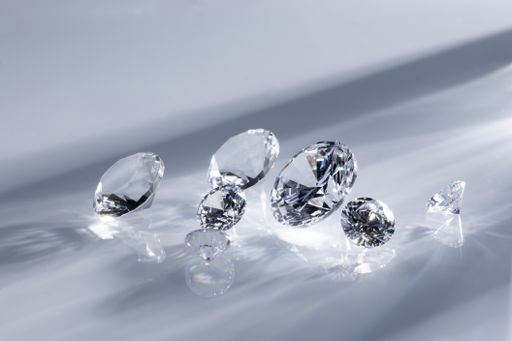 A closeup shot of beautifully cut diamonds on a white surface