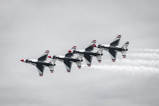 A selective color of the US Air Force Thunderbirds performing extreme maneuvers during an air show