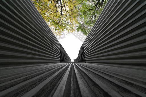 A low angle shot of a modern business building scenery touching the sky