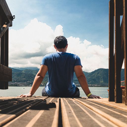 A man resting on a dock on a sunny day
