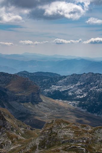 A vertical shot of the Durmitor mountains with a Bobotov Kuk peak during the daytime in Montenegro