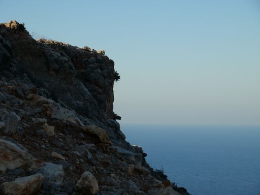 A closeup shot of a rocky cliff edge near the sea in Crete, Greece