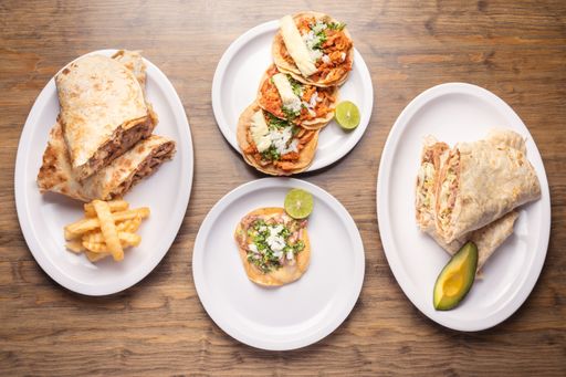 A top view of delicious and appetizing Mexican food on a wooden table