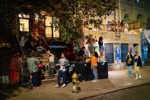 New Yorkers hang out at night on St. Mark's place, the center of the Manhattan's East Village neighborhood