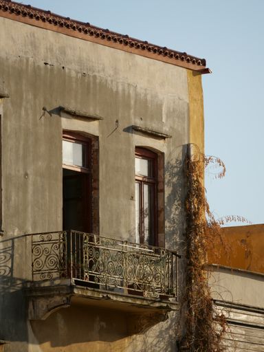 A vertical shot of a weathered building exterior