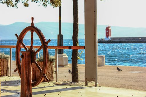 A selective focus shot an old vintage wooden helm wheel