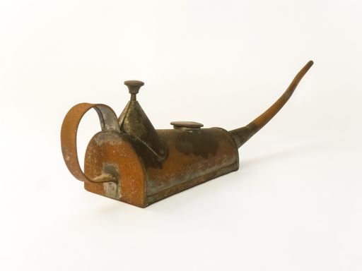 A closeup shot of an old rusty pump oil can with long spout isolated on a white background