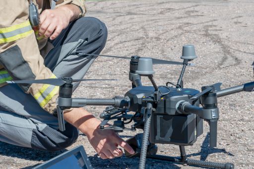 A firefighter flying a rescue drone