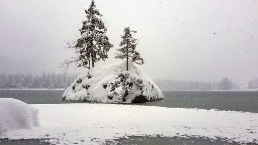 A beautiful view of a frozen lake covered with snow during winter
