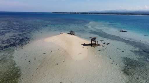 An aerial view of a wooden tower chair by the beach