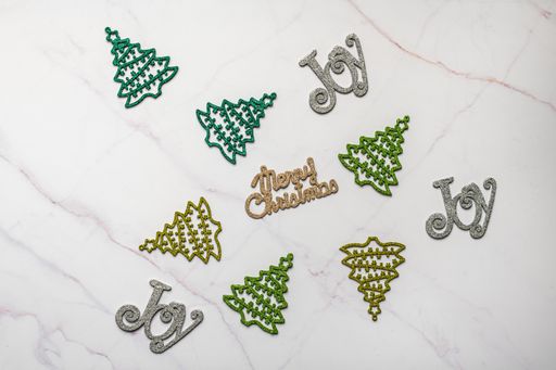 A top view of decorative Christmas tree ornaments on marble surface