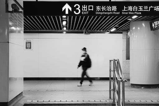 An unrecognizable man with a mask walking in the train station