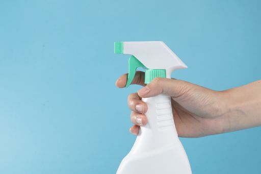 A selective focus closeup of a hand holding the alcohol spray-concept COVID19 prevention
