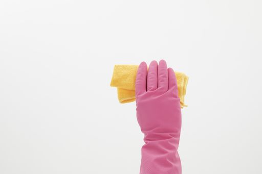 A selective focus closeup of a hand wearing a glove while holding a cleaning towel-concept COVID19 prevention