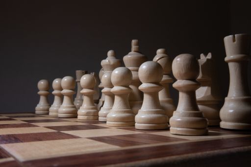 A lot of chess figures arranged on a chessboard with a black background