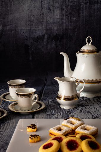 A vertical shot of coffee and tasty cookies on a table - Christmas mood